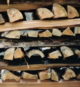 A crisscross stacked firewood end pillar used for stability.